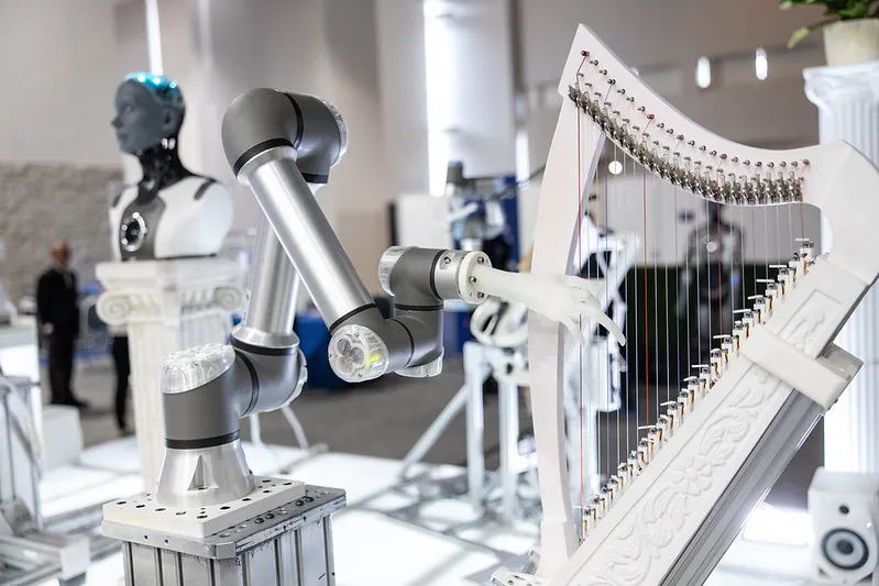 Robotic arm playing a harp at ai+expo 2026